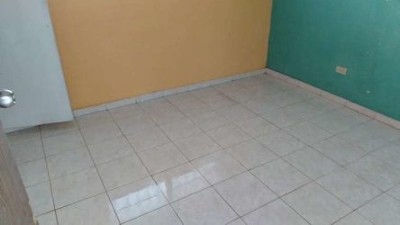 Empty bedroom interior with colorful painted walls tiled floor in Villas de La Alameda Arraiján Panama