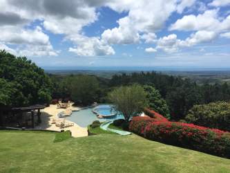 Luxury tropical swimming pool with ocean view surrounded by gardens at Rancho Santa Fe community Las Lajas Panama