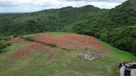 Aerial showing rolling hills and cleared land plots with forest at Rancho Santa Fe Las Lajas Panama