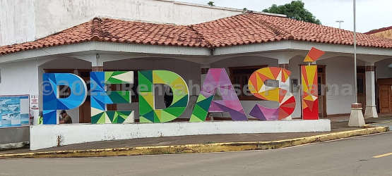 Colorful Pedasi sign and traditional building marking town center Pedasi Panama