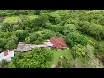 Traditional countryside house with red tile roof garden mature trees rustic charm San Carlos Panama