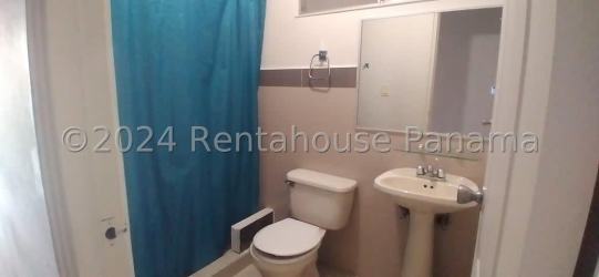 Simple bathroom with tile, pedestal sink, mirror and shower in Montelimar La Chorrera house