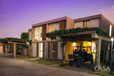 Open kitchen with island seating, pendant lights, granite counters in Las Islas villa Punta Barco