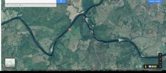 Aerial photo of winding river bordering dense forest and cropland in Veraguas