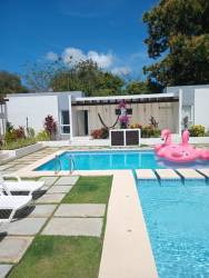 Modern kitchen with light wood cabinets granite countertops in beach house Coronado Panama