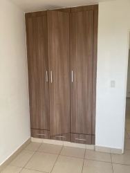 Bedroom with wooden wardrobe beige tiles white walls PH Terrazas del Oeste Panama