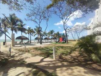 Living room with large glass door opening to ocean view balcony Playa Caracol Panama