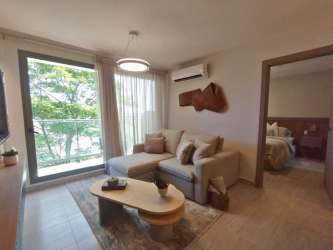 Bright minimalist living room with large window at PH Parterre in Panama Pacifico