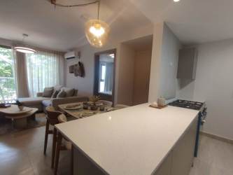 Resort-style swimming pool with lounge chairs at PH Parterre Panama Pacifico