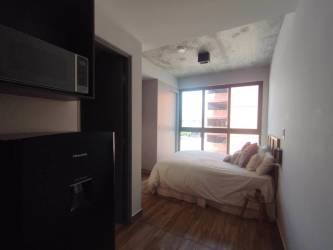 Infinity pool with mountain views and lounge space at PH Centriqo Panama Pacifico