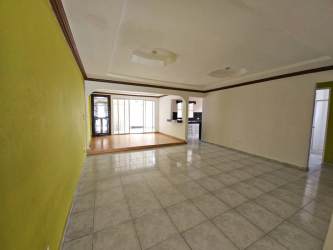 Spacious living room with green accent wall, tile floor, ceiling detail in Brisas de Arraiján Panama