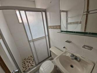 Bathroom with glass shower, white sink, tile walls in Brisas de Arraiján Panama Oeste