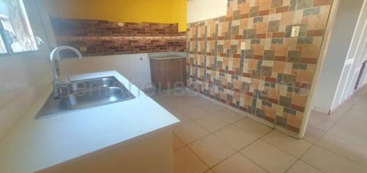 Backyard fenced green space with cement area in Panama house for sale