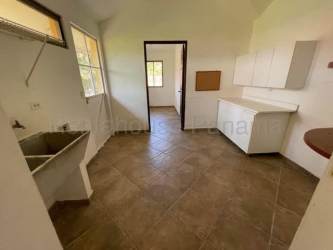 Open plan living area vaulted ceiling tile floor beach house Panama