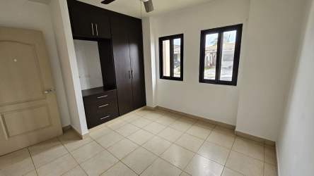 Bedroom featuring large window, built-in closet, ceramic tiles PH Summer Hills Costa Verde