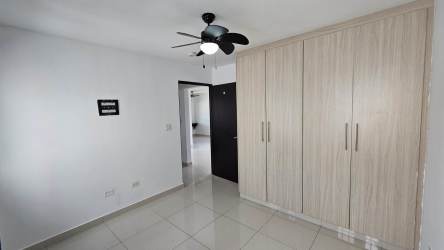 Minimalist bright bedroom with ceiling fan and built-in closet in PH Spring Hills Costa Verde Panama