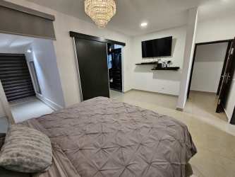 Open concept kitchen with breakfast bar oven stove in house Costa Verde Panama