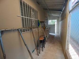 Modern bathroom with pedestal sink corner shower glass door Villas del Campo La Chorrera Panama
