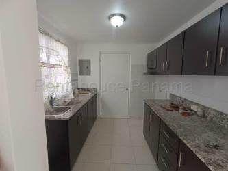 Kitchen with granite counters dark cabinetry double sink in Villas del Campo Chorrera Panama