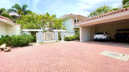 Contemporary kitchen with island breakfast bar, wood cabinetry and stainless appliances in lakefront Buenaventura villa Panama