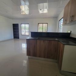 Kitchen with wooden cabinets, open living area with tiled floors Aguadulce Coclé Panama