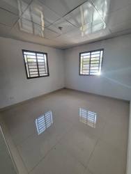 Empty bedroom with tiled floors, windows with security bars in Aguadulce Panama
