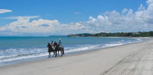 Horseback riding on sandy beach near Coronado Panama property for sale