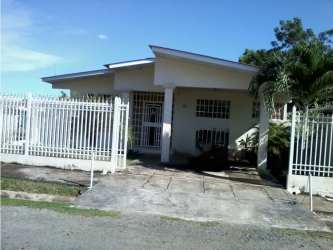 Large living and dining room with ceramic tile flooring, natural light, and traditional furniture in house in Chitré Panama