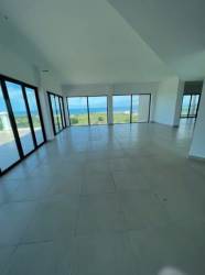 Contemporary kitchen with granite countertops, wood cabinetry in luxury Vista Mar penthouse Panama