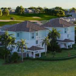 Aerial view of Mediterranean-style villas beside golf course at Bijao