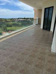 Bright modern living room with sliding doors to panoramic terrace in PH Fairway Estates Panama Pacifico