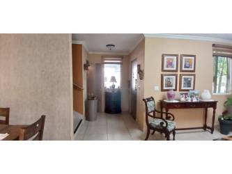Kitchen with laminate countertops, ceramic backsplash, stove and ventilation hood in house at Bosques del Pacífico Panama Pacifico