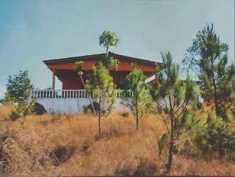 Orange single-story rural house with flat roof and detached carport on ample ocean view land Panama