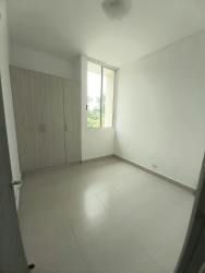 Empty bedroom with large window, built-in closet, and ceramic floors in PH Natura Costa Verde Panama Oeste