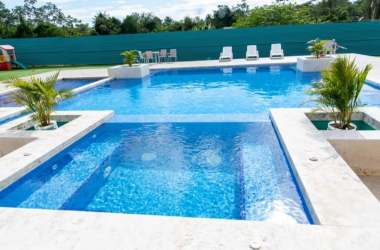 Bright modern kitchen with granite countertops, upper cabinets, and window at PH Natura Costa Verde Panama