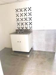 Laundry space with ventilation blocks and utility sink in Vacamonte house for sale