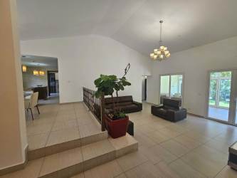 Spacious living room with tile floor, large windows, open plan at PH Tucan Country Club Cocoli Panama