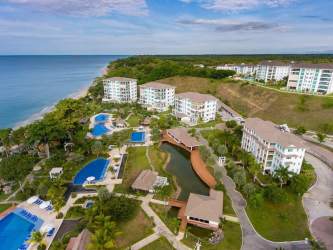 Aerial photo oceanfront condos pools green landscaping Bijao Beach Panama