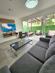 Living room of furnished beach villa leading to private terrace in Coronado Panama