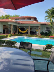 Mediterranean style patio overlooking private swimming pool Coronado Panama villa