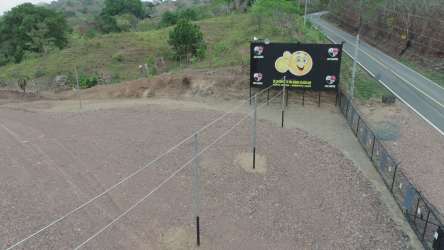 Aerial view fenced commercial roadside lot with billboard Playa Venao Panama