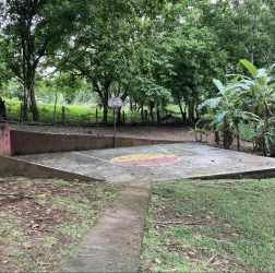 Concrete sport court surrounded by trees and nature at rural estate in Capira Panama