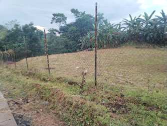 Grassy vacant lot fenced with roadside access in Arraiján Panama for sale