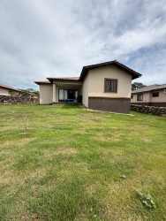 Large garden and lawn area behind the house in Volcán Los Mandarinos rental home