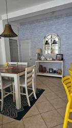 Dining area with coastal accents, blue wall, white dining set, pendant light Playa La Barqueta Chiriquí Panama
