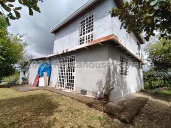 Exterior unfinished country house surrounded by lush green yard Playa Blanca Coclé Panama