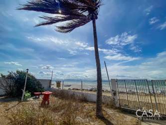 Shaded terrace area with dining space facing ocean beach in Punta Chame Panama