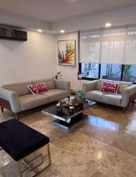 Modern kitchen with large island, stainless steel hood, window lighting in PH Nativa Panama Pacifico