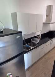 Bedroom featuring vaulted ceilings, large window and garden view in PH Nativa Panama Pacifico