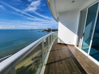 Bright open-plan living room with floor-to-ceiling windows and ocean view at Ocean Waves Panama